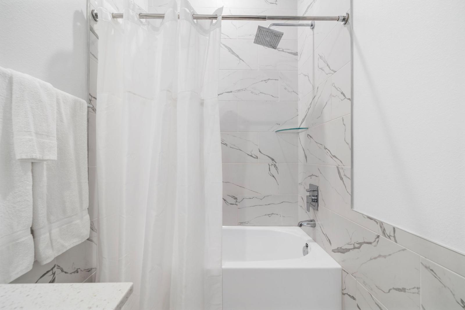 Bathroom 1 with a bathtub and shower combo