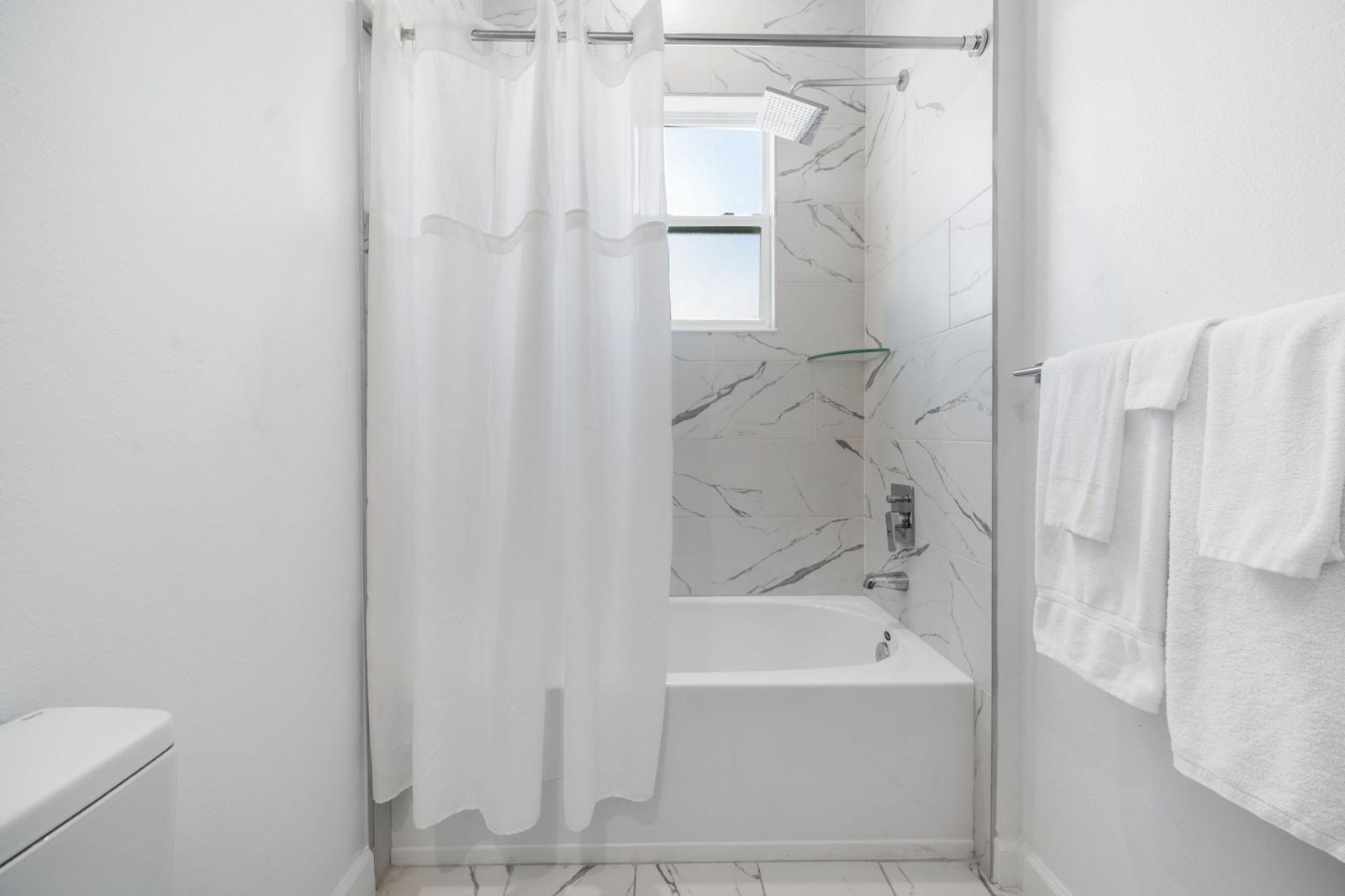 Bathroom 4 with a bathtub and a shower combo