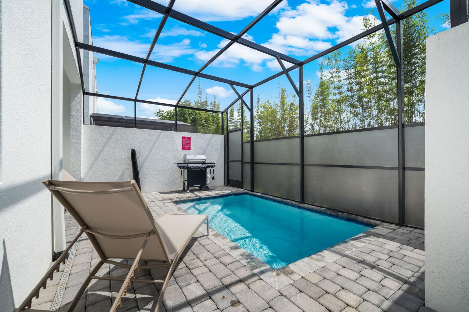 Private pool with BBQ grill and lounge chairs