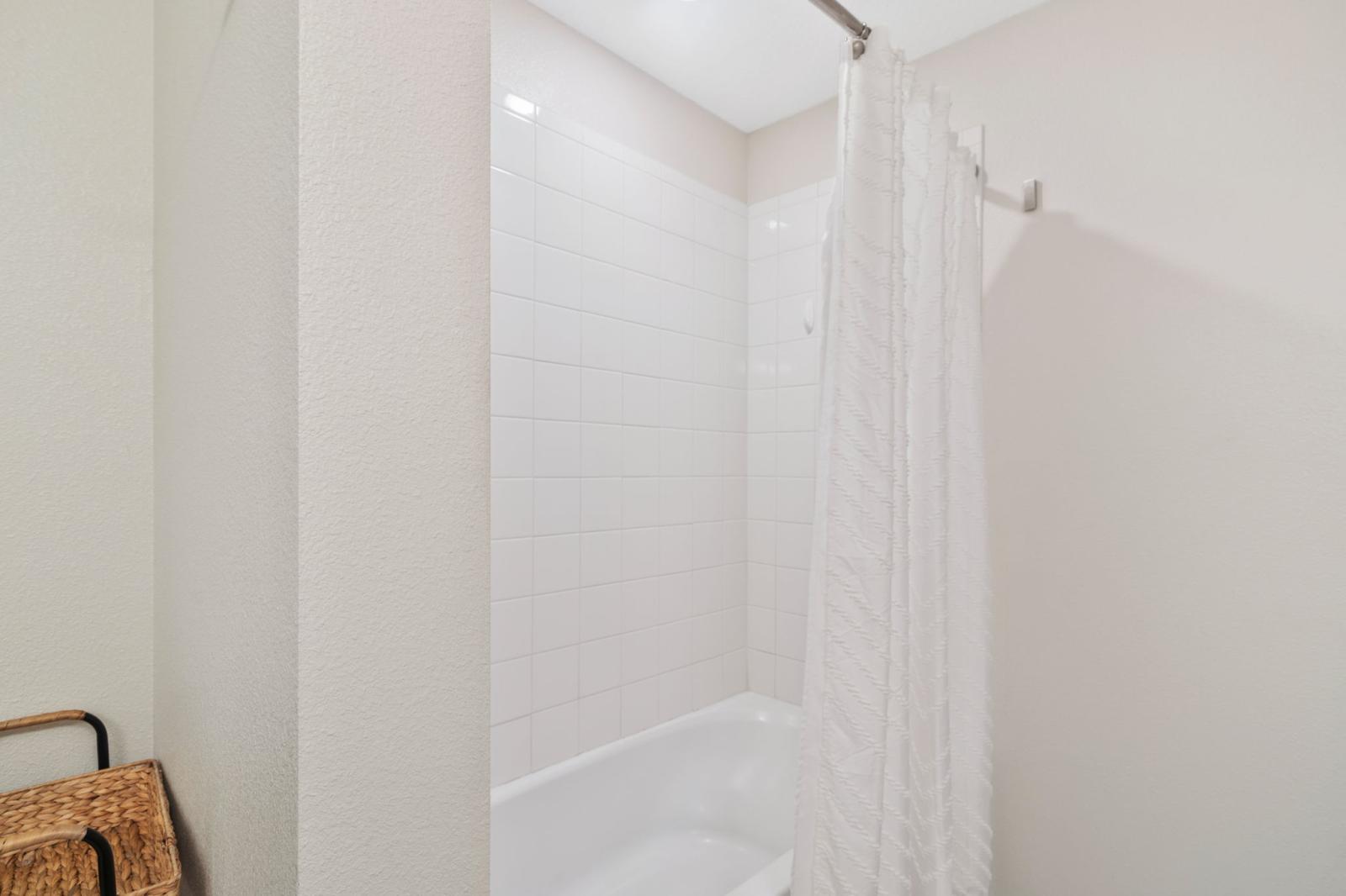 Bathroom 2 with a bathtub and a shower combo