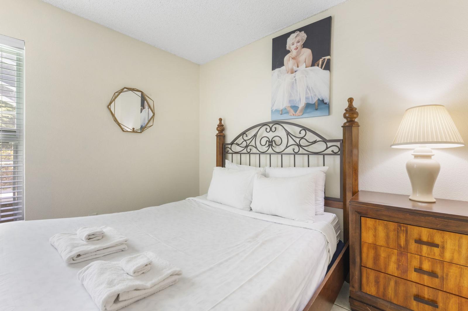 Inviting guest bedroom with a comfortable full-size bed, bedside lighting, and tasteful decor — perfect for a restful night after a day of adventure.