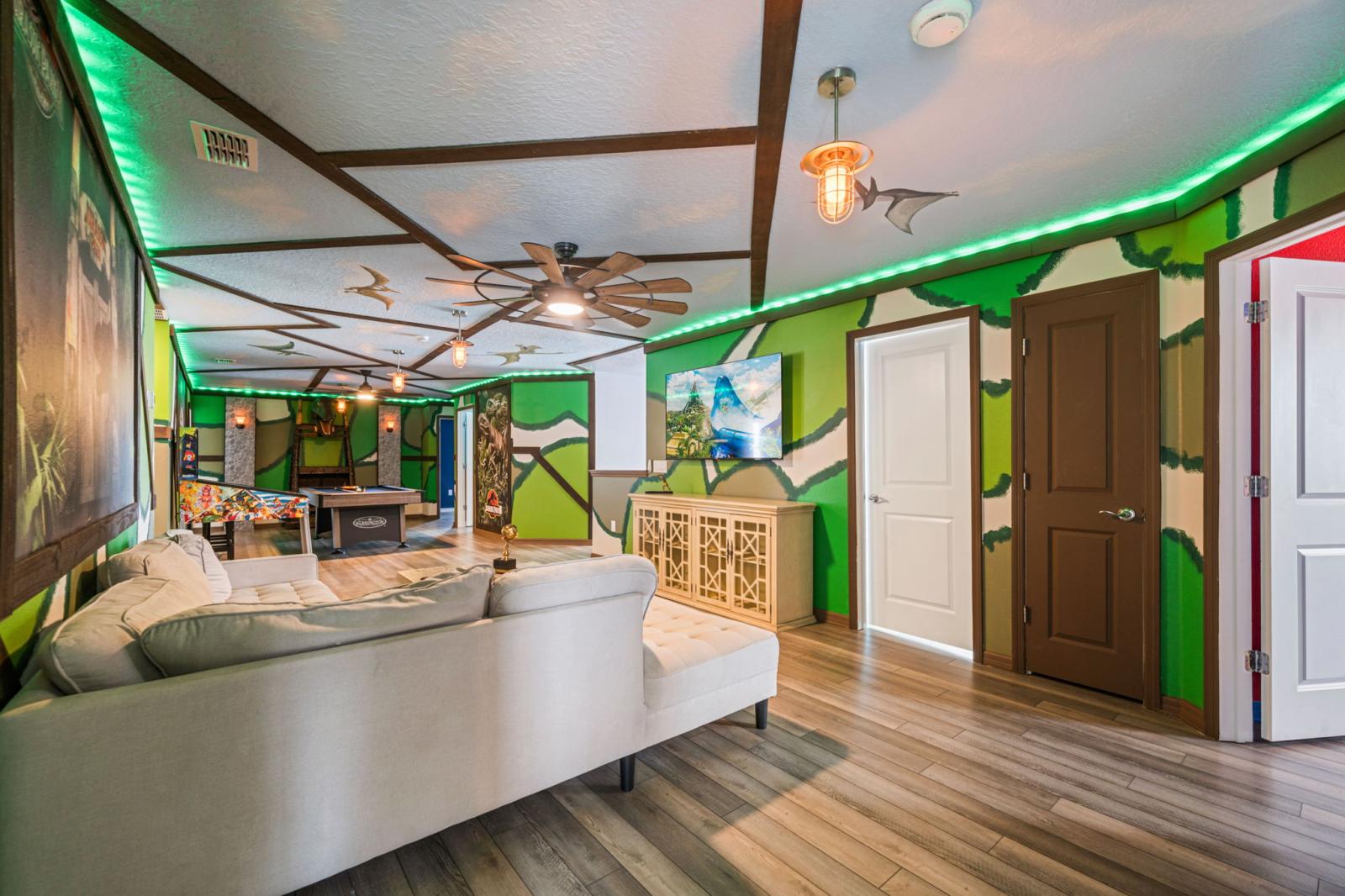 Loft area with a pool table and an arcade games and a smart TV