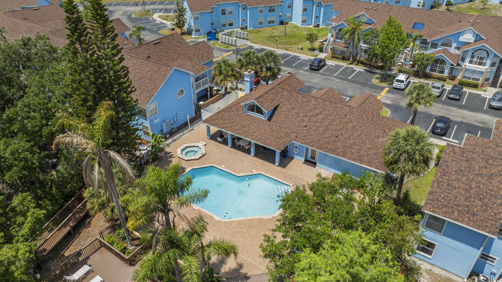 ☀️ Bird’s Eye View of Resort Amenities – Relax and recharge at the community pool and hot tub, surrounded by palm trees, sun loungers, and shaded seating. Just steps from your villa in this beautifully maintained complex. #ResortLiving #Poolside #VacationC