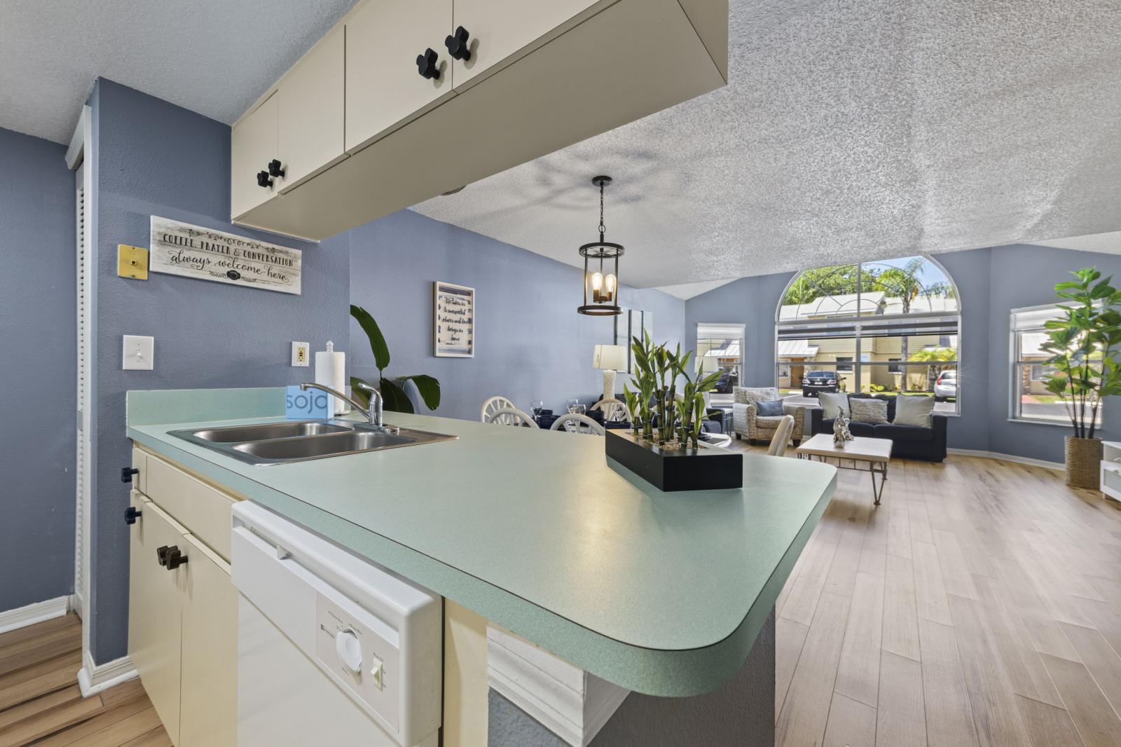 🍴 Kitchen with a View – This open kitchen flows into the living and dining area, offering easy meal prep and connection with the rest of the home—plus a great view of the bright, vaulted-ceiling living room. #OpenLayout #FamilyDining #FullyEquippedKitchen