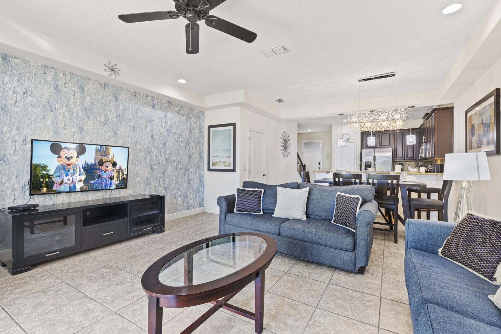 Spacious and sunlit living area featuring plush seating, modern décor, and smart TV—ideal for relaxing after a day of adventure.