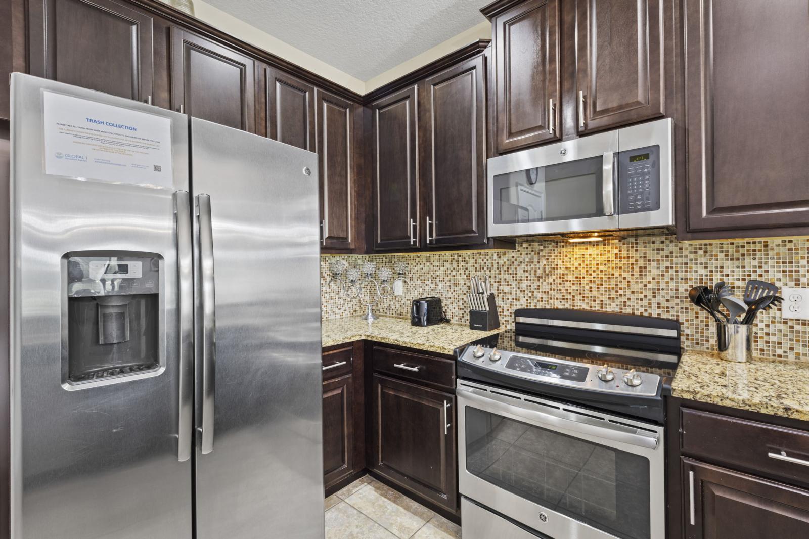 Fully equipped kitchen with stainless steel appliances, granite countertops, and all the essentials for home-cooked meals