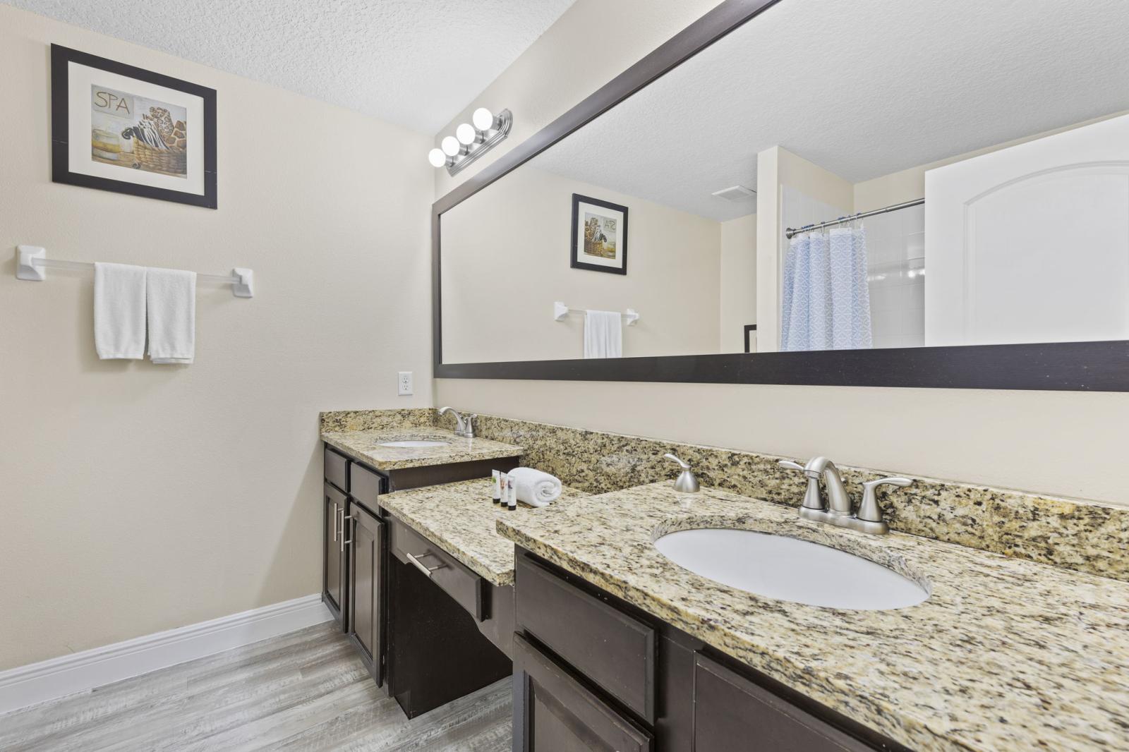Spacious and stylish, the primary bathroom features double sinks with ample counter space and a convenient tub/shower combination—perfect for both quick rinses and relaxing soaks.
