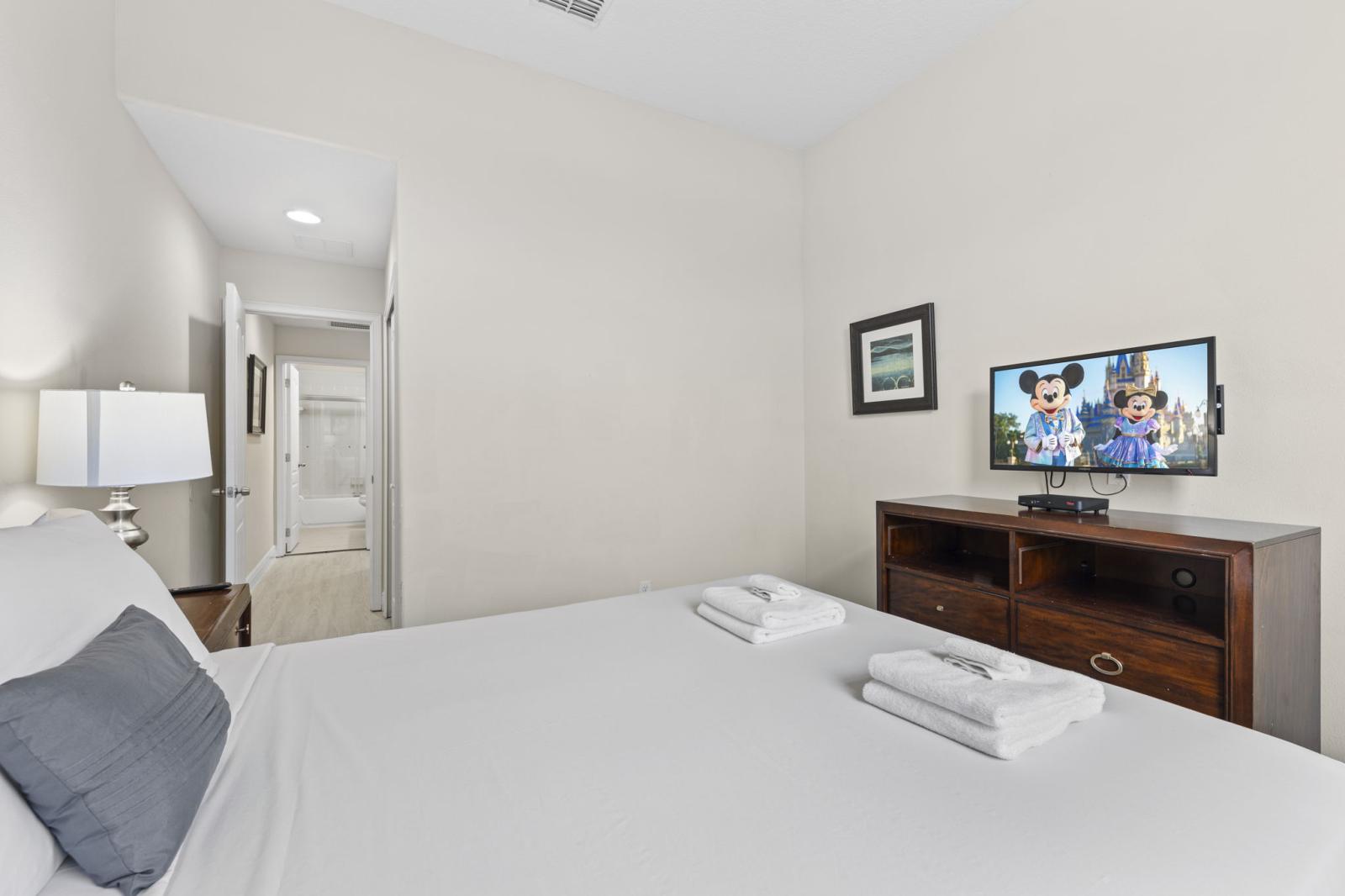 Cozy guest room featuring a queen bed and ample closet space—perfect for couples or kids.