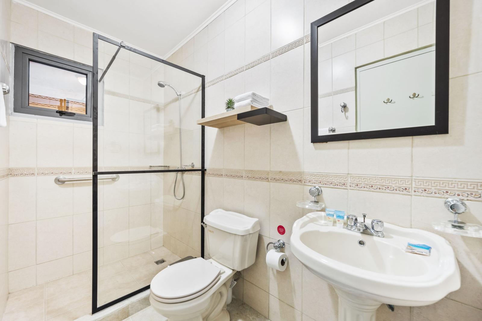 bathroom 1 offers a walk in shower