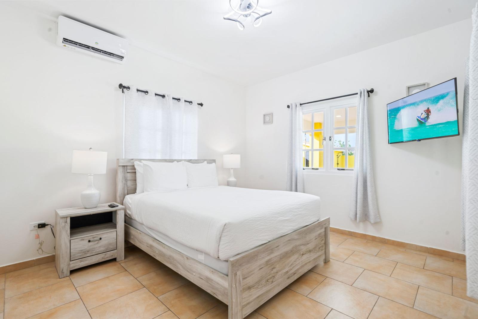 Bedroom 2 features a double size bed and a wall mounted smart TV