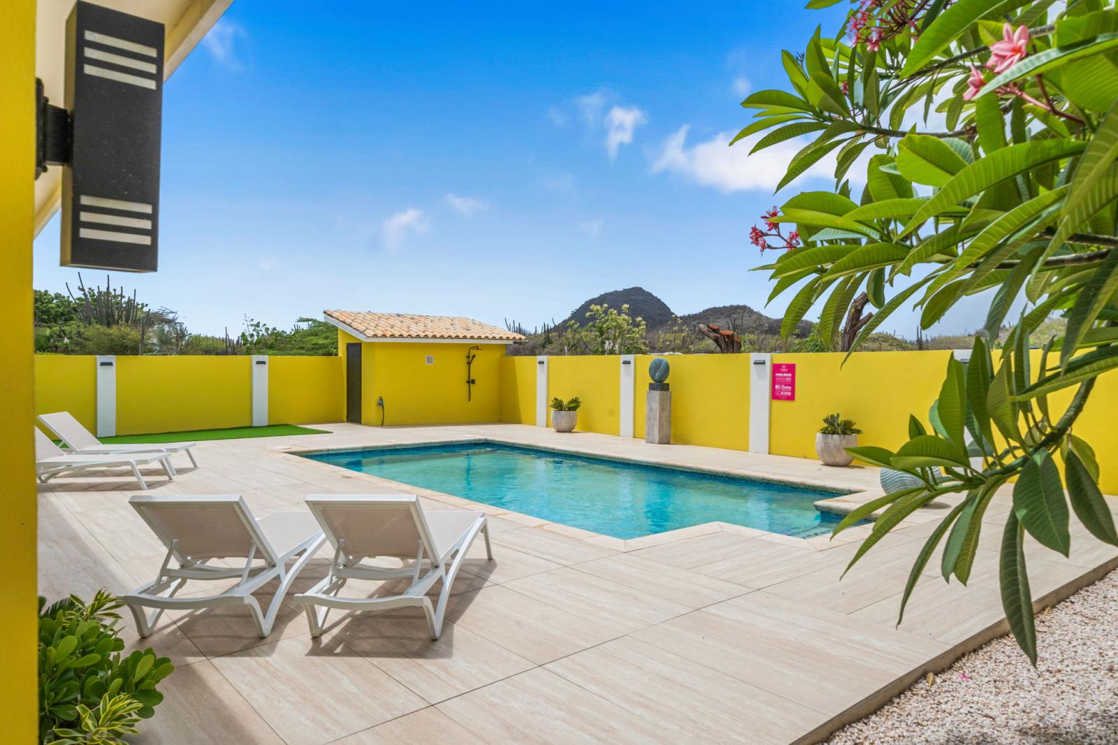 Shaded lounge seating by the pool