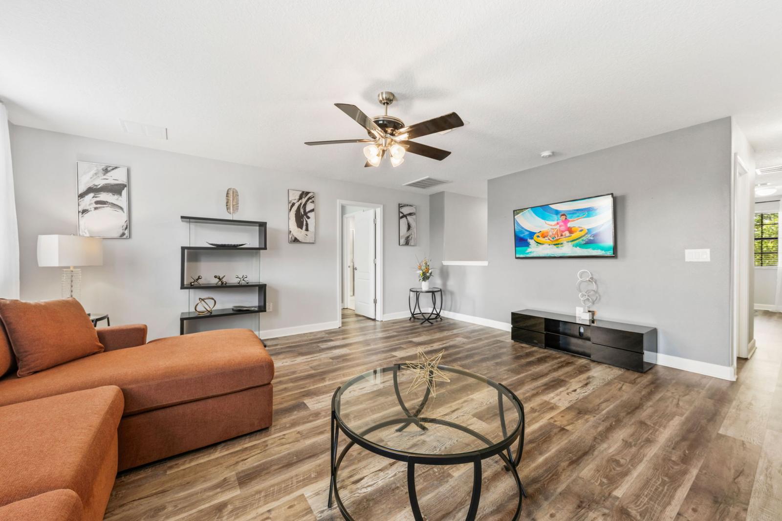 Loft area with a large couch and Smart TV