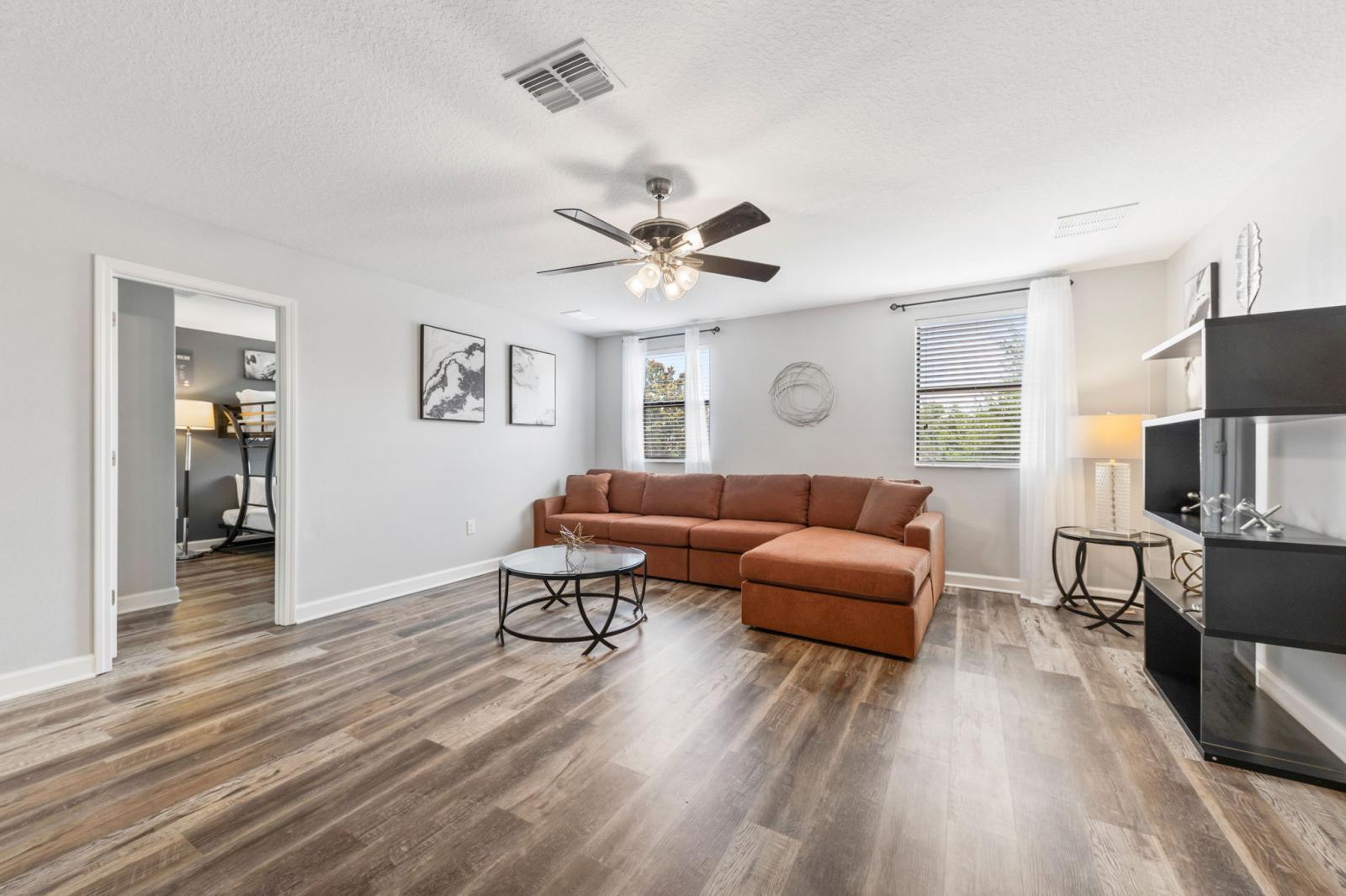 Loft area with a large couch and Smart TV