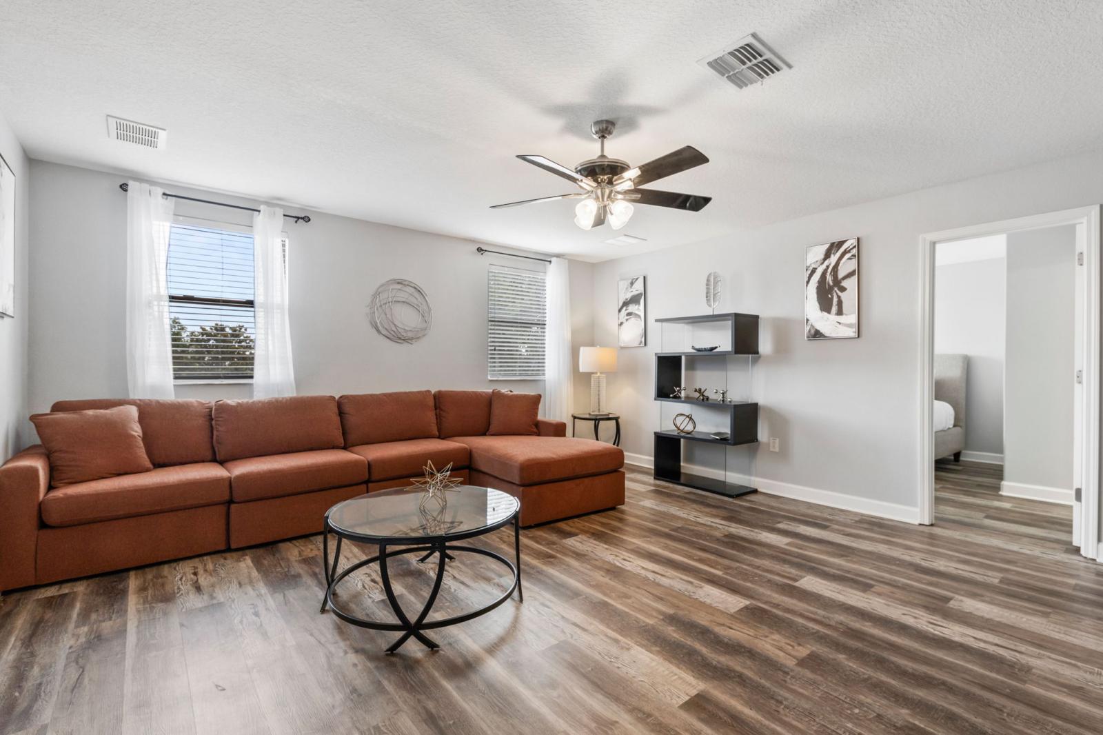 Loft area with a large couch and Smart TV