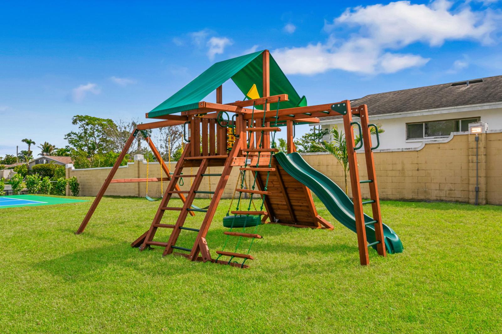 Large backyard with playset for kids to run and play