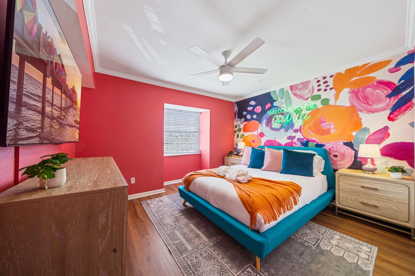 Bedroom 4: Inviting queen-size bedroom located on the second floor, featuring a refreshing ceiling fan and a large 65" smart TV for ultimate comfort and entertainment.