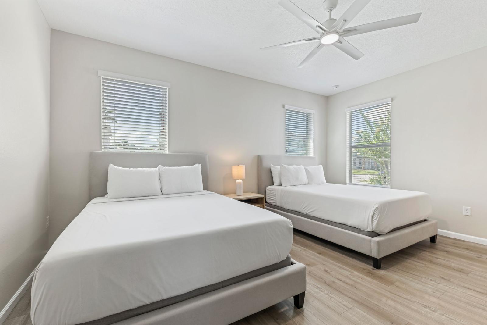 Bedroom 1 with 2 queen size beds and a private bathroom