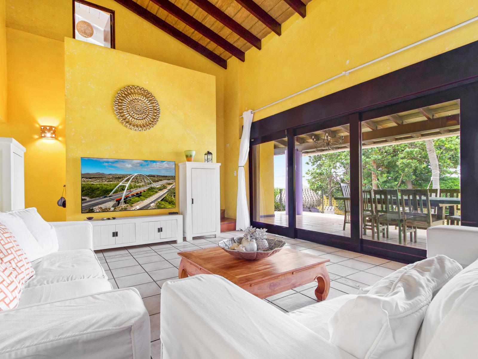 Spacious living room with smart TV and sliding doors to patio (1)