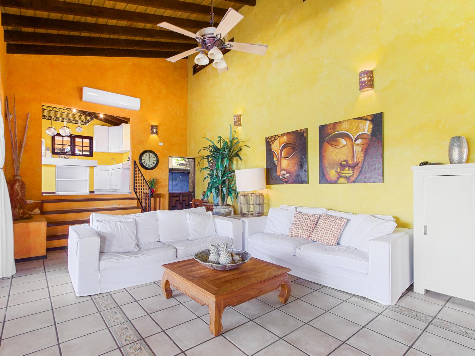 Living room where comfort meets style with kitchen in the back