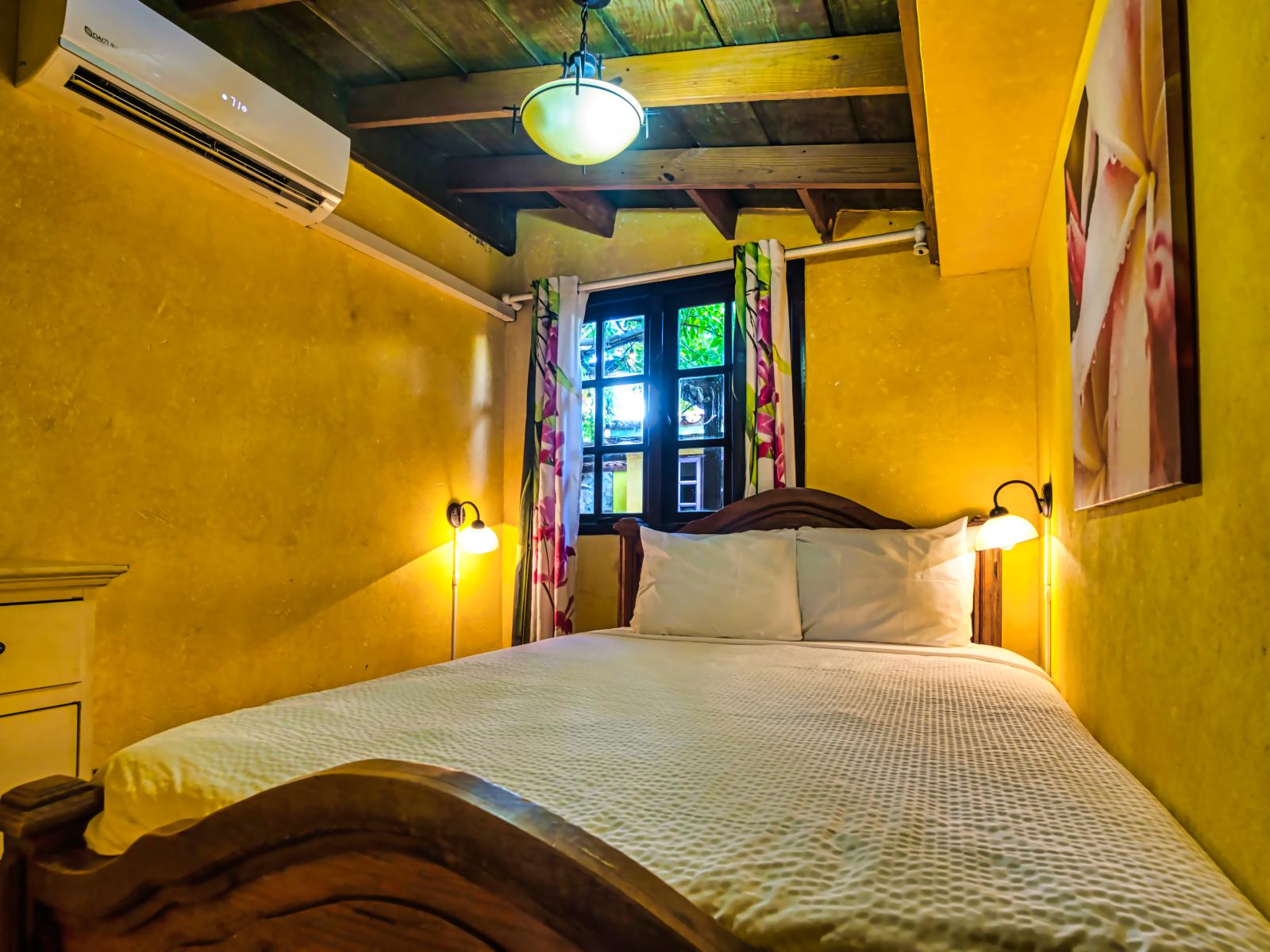 Aesthetic bedroom of the villa in Oranjestad Aruba - Comfy king size bed - Elegantly designed room beautifully decored with large aesthetic wall painting - Majestic wall lamps and great chandelier - Neat and clean linen - Exclusive wardrobe