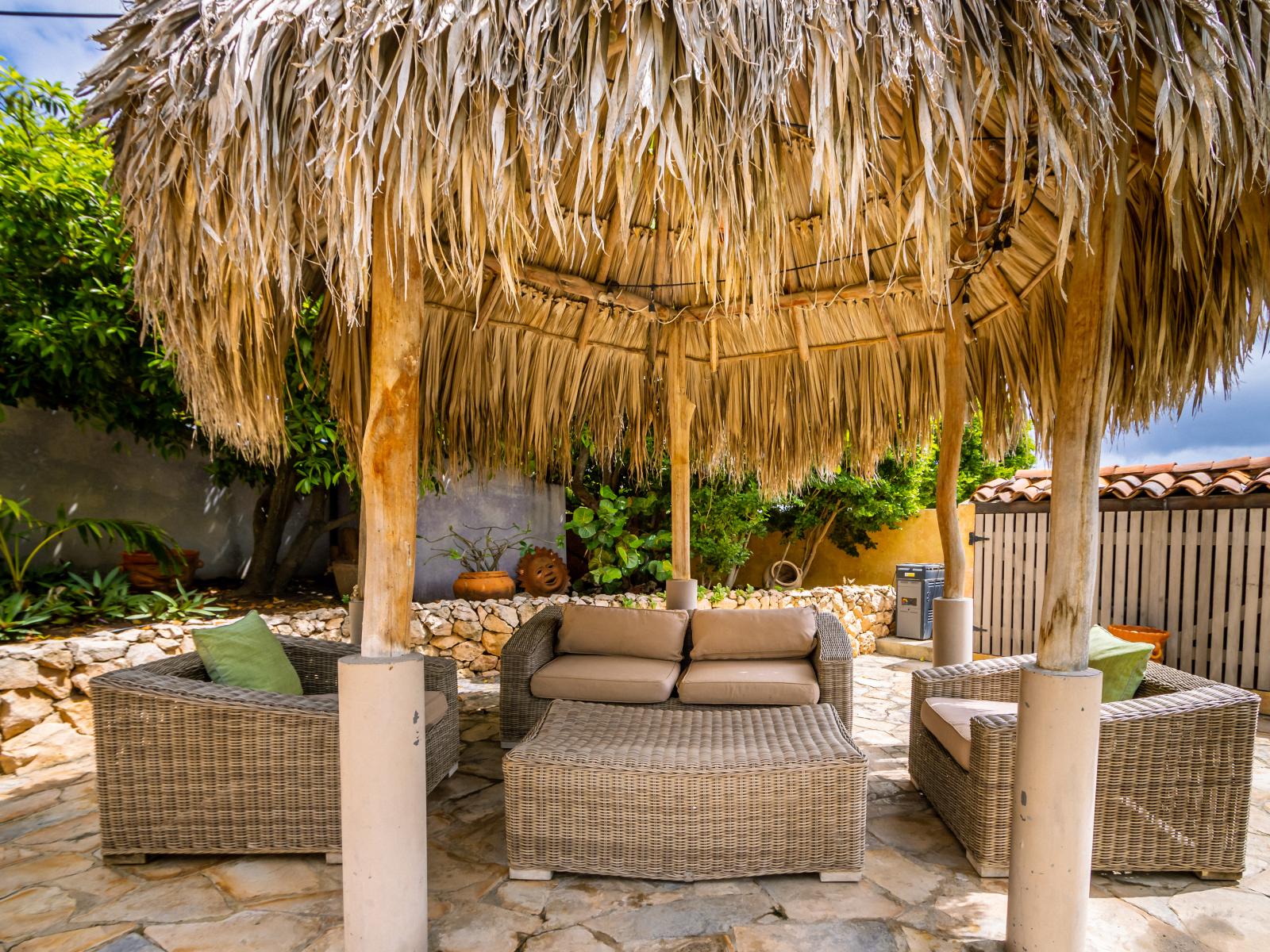 Enjoy the outdoors in comfort at our serene gazebo lounge, complete with plush seating.