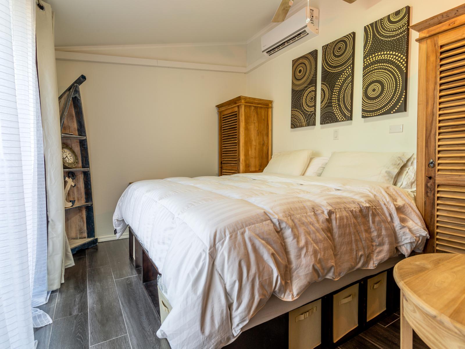 Magnificent Bedroom of the Apartment in Noord Aruba - Modern bedroom with sleek design and natural light - Smart use of space with efficient storage solutions - Luxurious bedding for a restful night's sleep