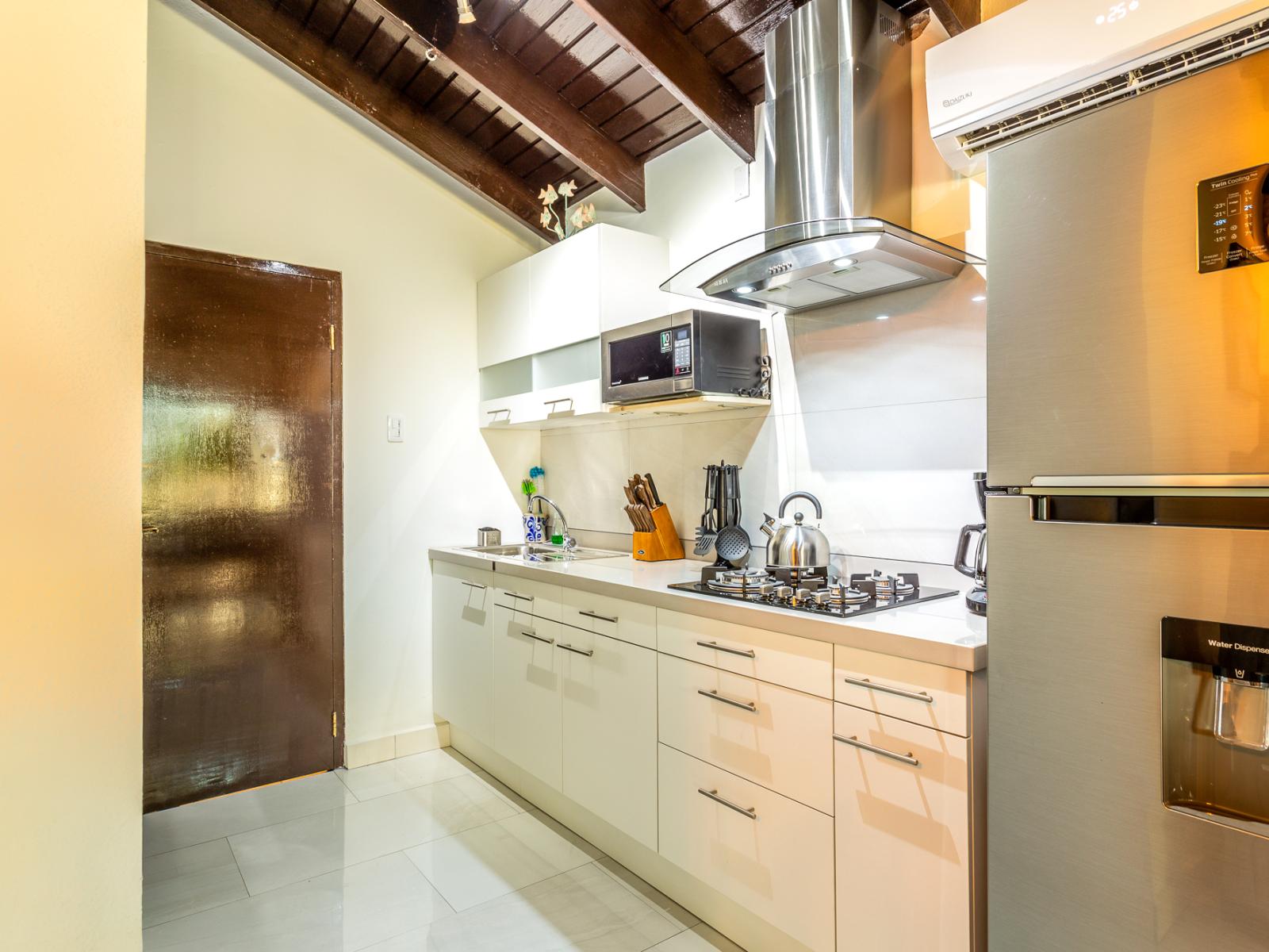 Spacious Kitchen area of Apartment in Marina - Fully equipped with kitchen Accessories - Smart use of space with versatile storage solutions -  Sleek stainless-steel appliances