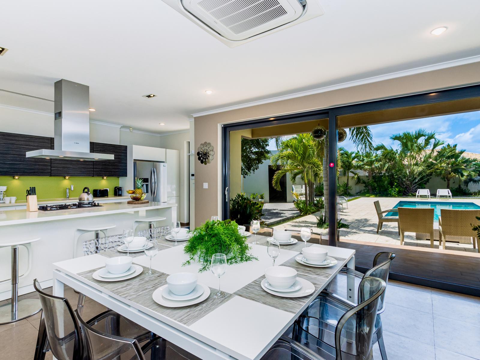 Gourmet kitchen meets elegant dining: enjoy a fully furnished, modern kitchen fronting the dining table.