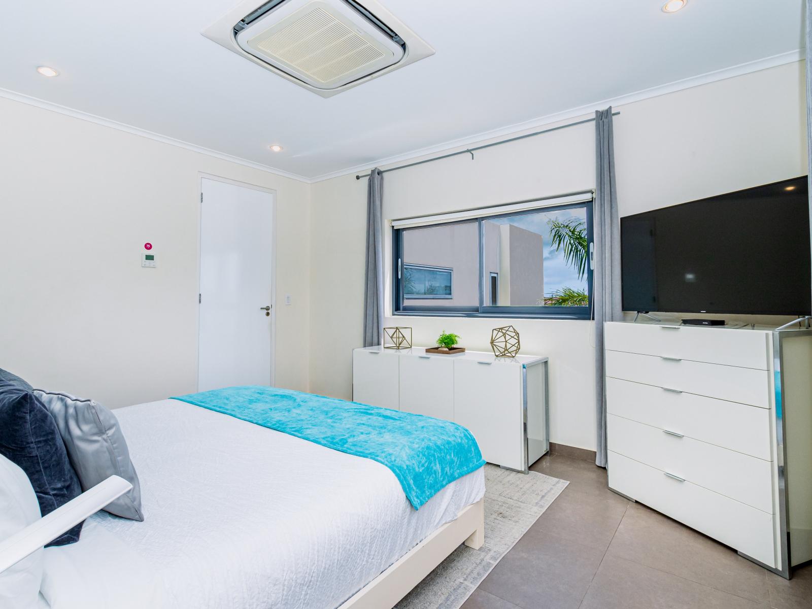 Bedroom 1 includes a window that overlooks the backyard, providing a peaceful outlook.