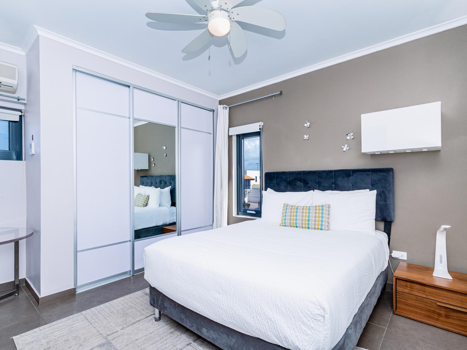 Enjoy a restful stay in Bedroom 3, complete with a queen-size bed and a TV.