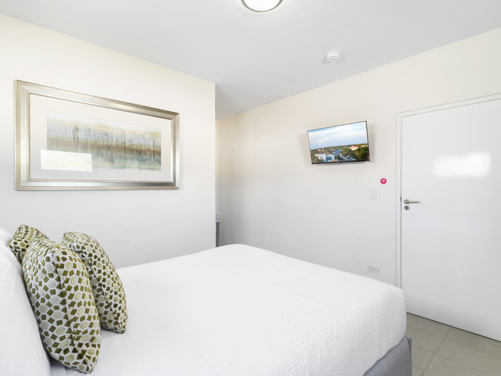 Relax in Bedroom 6, which includes a queen-size bed and a TV for your enjoyment.