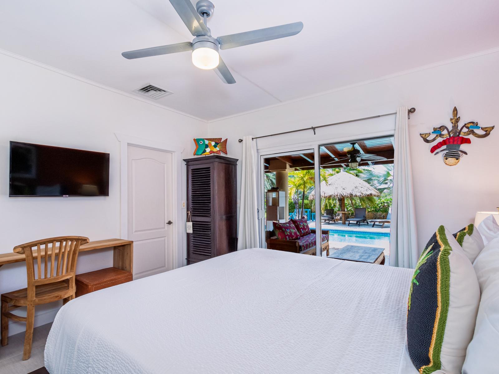 Main Bedroom 1 features a private entrance to the backyard, offering a serene escape and seamless indoor-outdoor living.