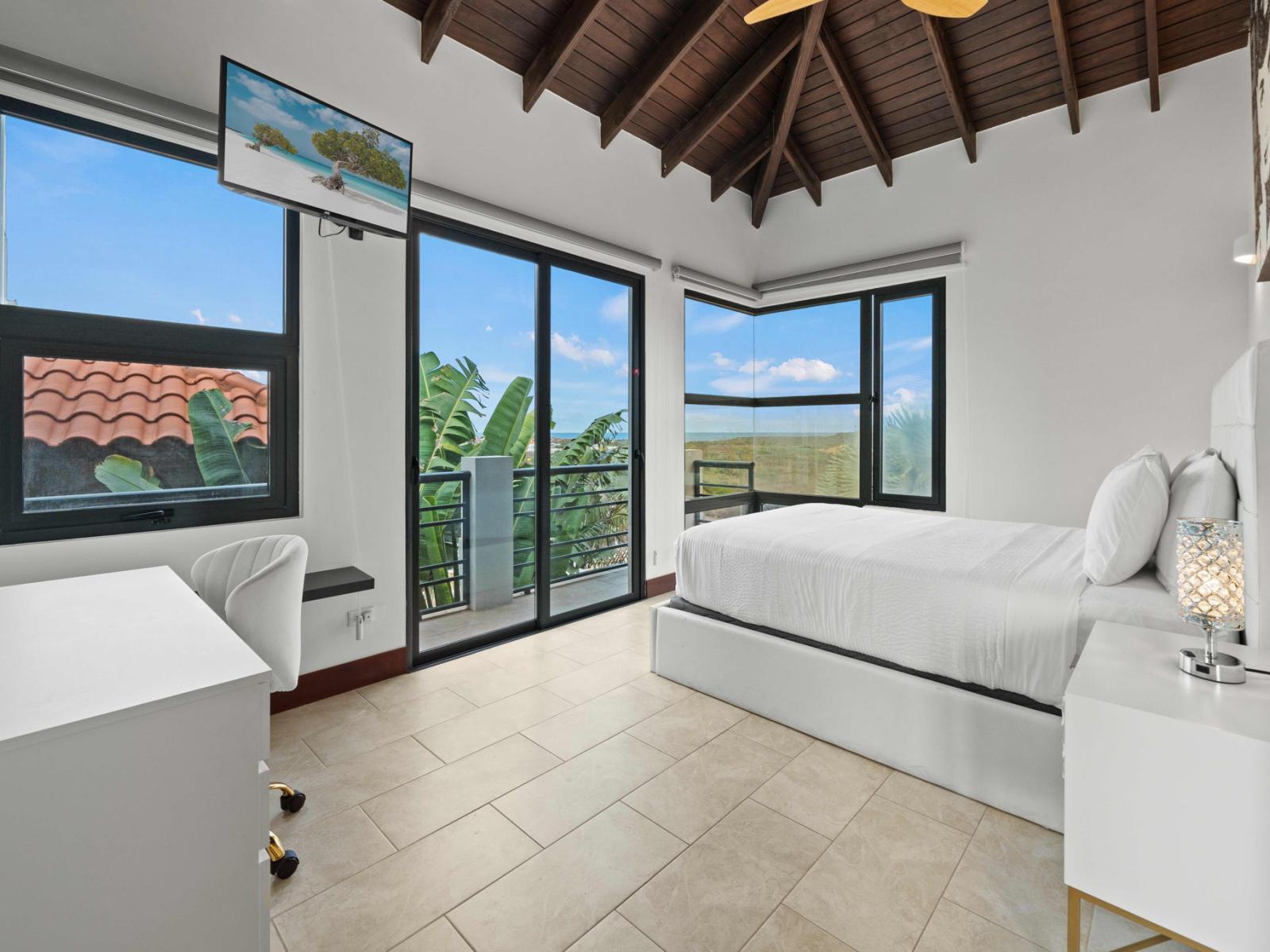 Bedroom 2 features a queen size bed and glass doors to your own private balcony