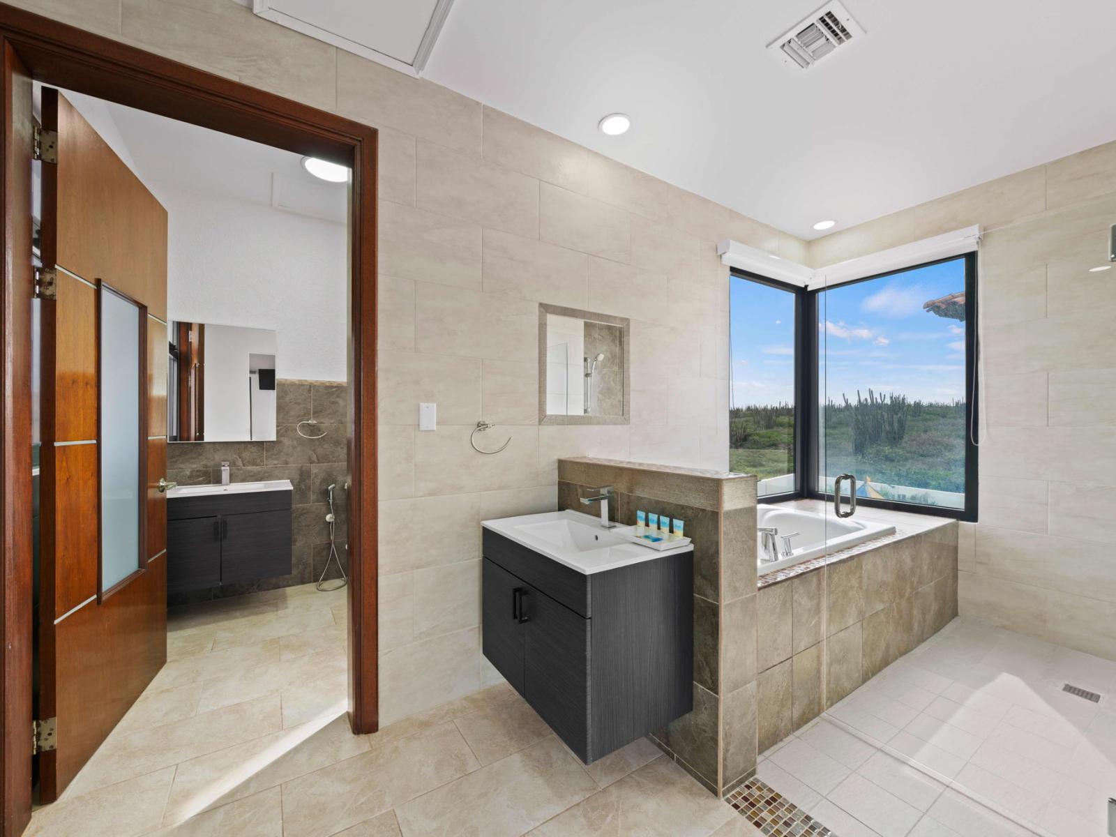 Bathroom 2 offers a bath tub and a walk in shower