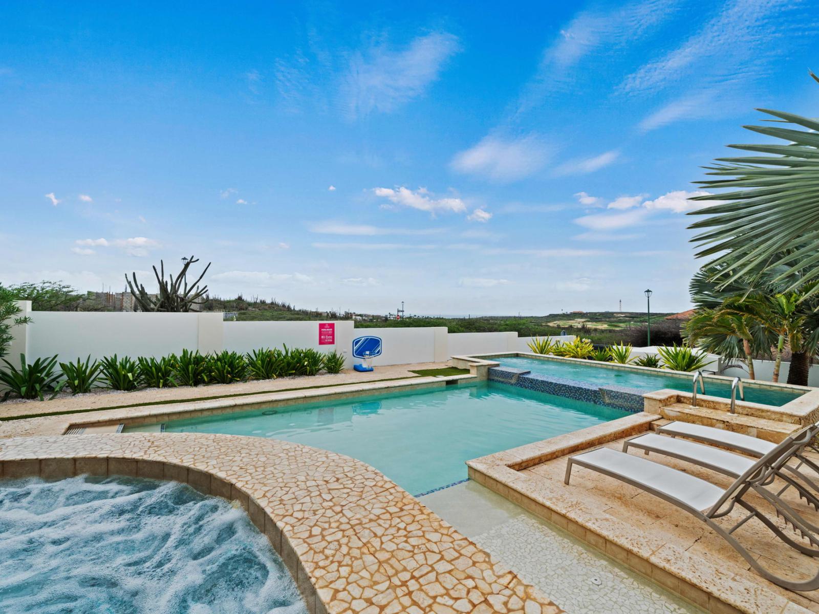 In the backyard you will find a refreshing pool with plenty of lounge chairs to soak up the sun