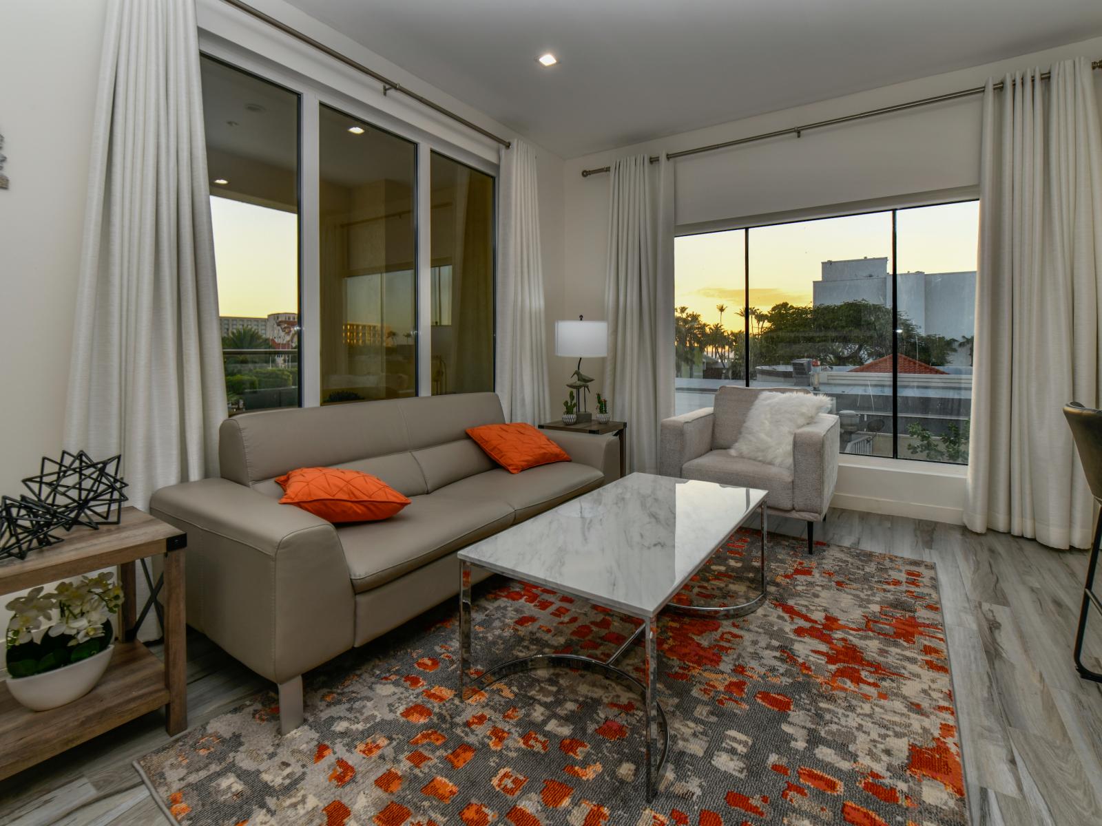 Posh Living Area of the 2BR condo in Noord Aruba - Comfy sofas - Smart TV and Netflix - Thoughtful mix of textures, from plush rugs to tasteful throw pillows