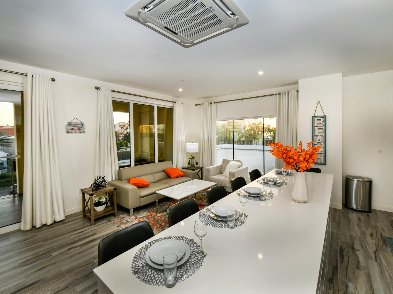 Elite living area of thee 2BR condo in Noord Aruba - Cosy sofas - Elegantly decored living area - Large bright windows of the living area with Mesmerizing views - Beautifully furnished floor - Availability of TV and Netflix