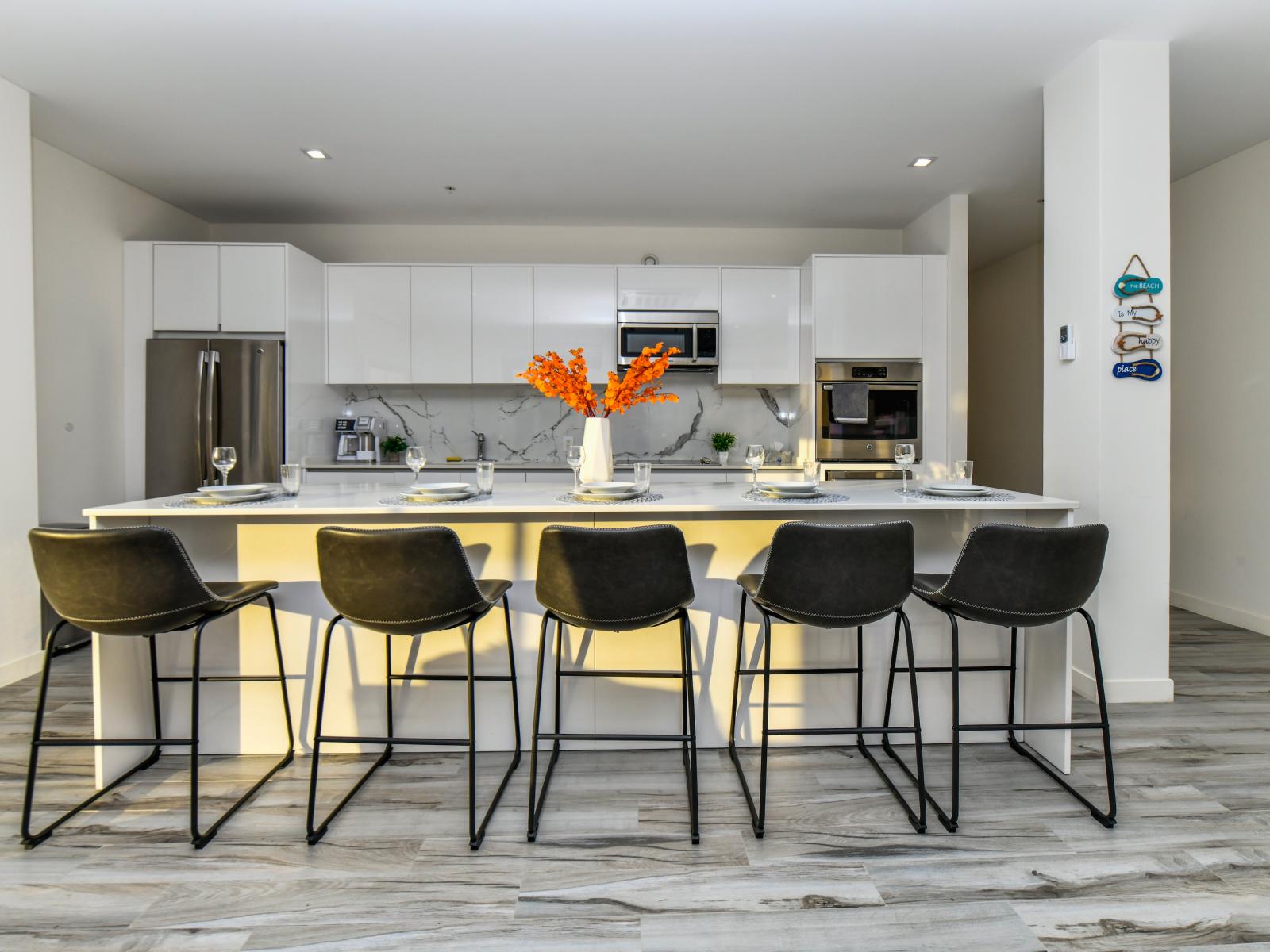 Cook with ease in our Noord Aruba 2BR condo's fully equipped kitchen - featuring all essential accessories, abundant storage, spacious work areas, a bright atmosphere, and available high chairs.