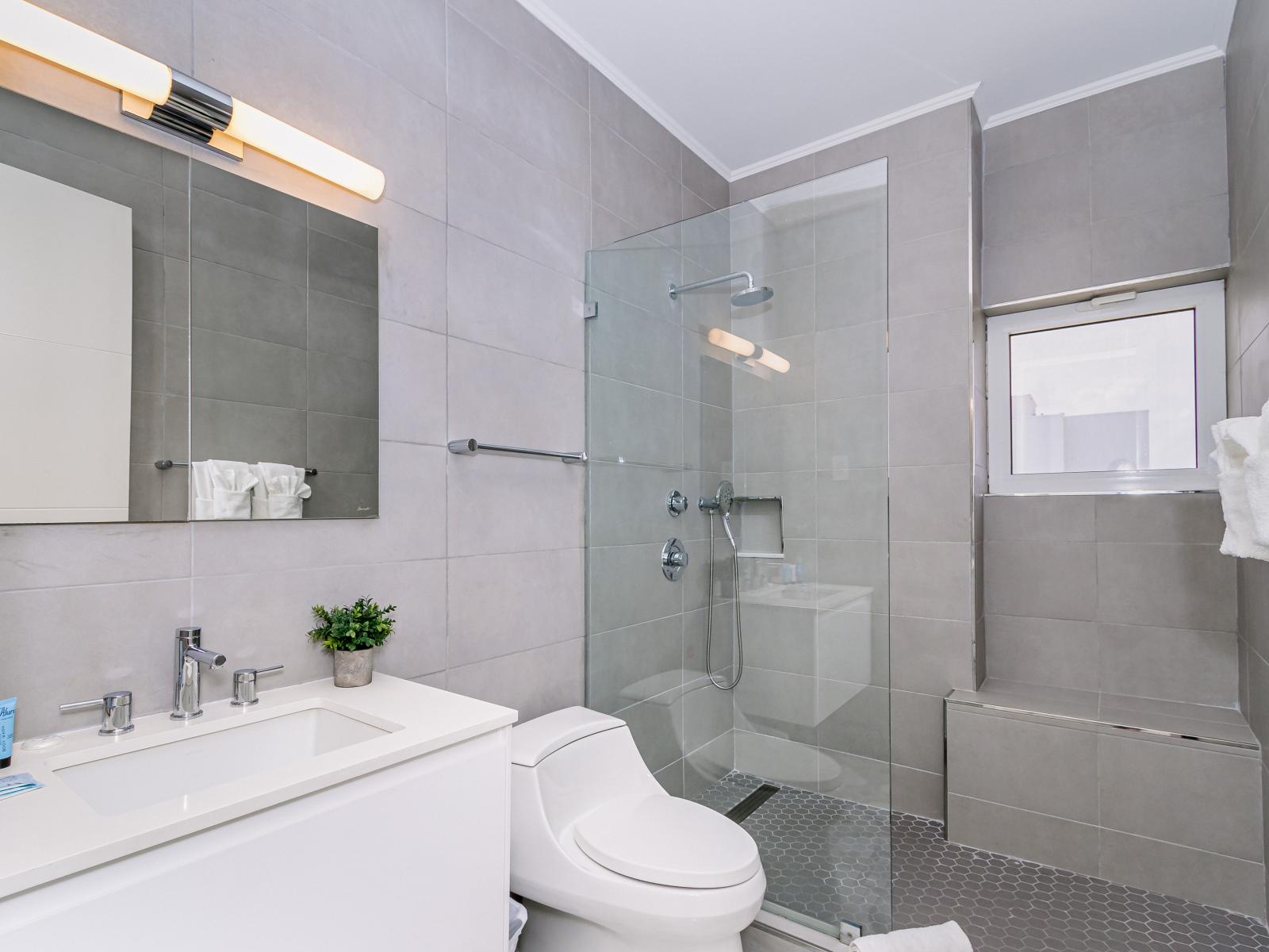 Classy Bathroom of the 2BR condo in Noord Aruba - Beautiful Vanity with large size wall mirror - Sufficient storage space - Neat and clean toilet seat - Availability of all bathroom amenities