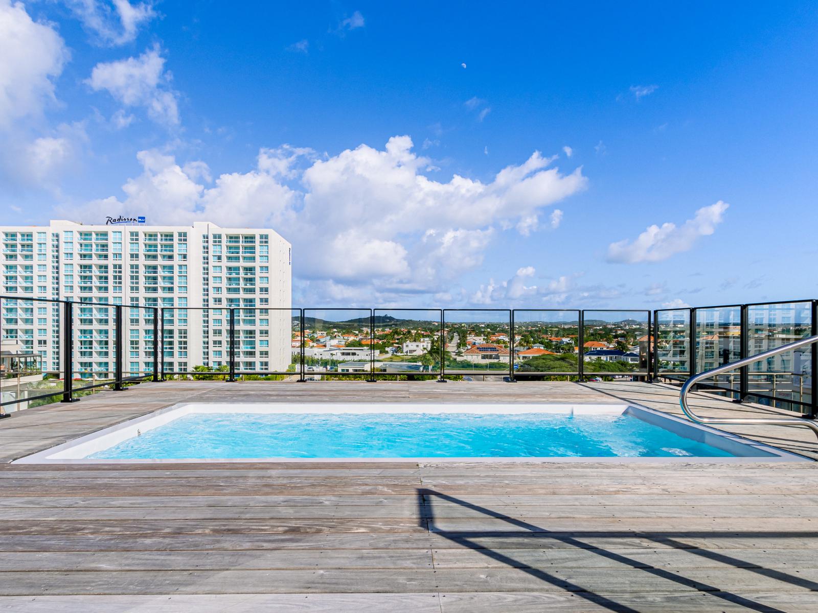 Splendid Pool of the 2BR condo in Noord Aruba - Cosy beach chairs available - Dive into refreshing poolside escape - Immerse yourself in the cool elegance of our pool - Experience ultimate relaxation in our poolside paradise