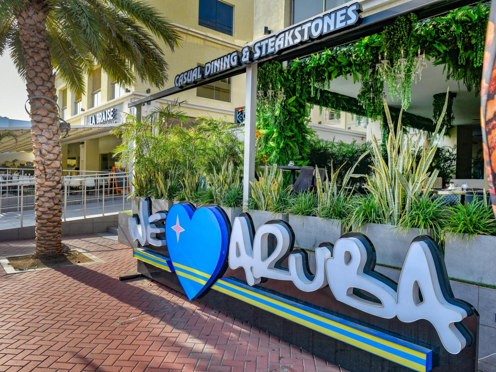 Snap a photo at the iconic 'We Love Aruba' sign just steps from the condo.