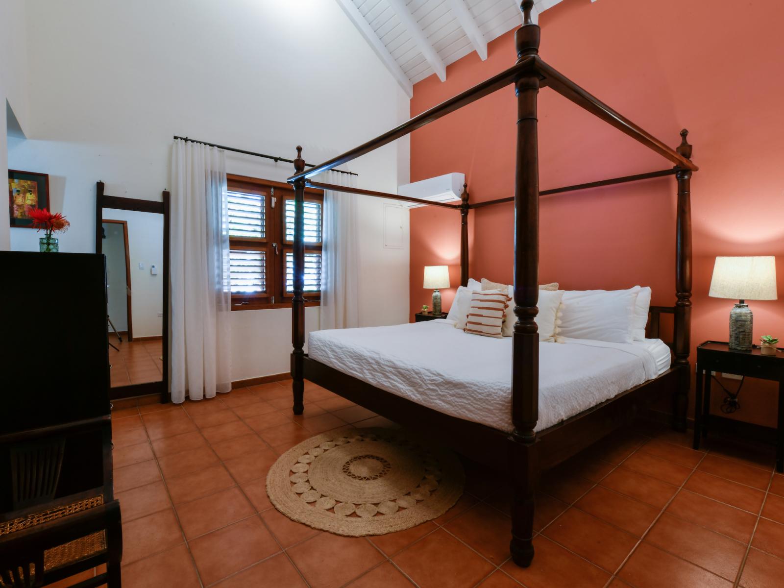 Lavish bedroom of the villa in Noord, Aruba - Comfy king size bed - Elegantly designed room beautifully decored with large aesthetic wall paintings - Majestic table lamps - Neat and clean linen with soft pillows