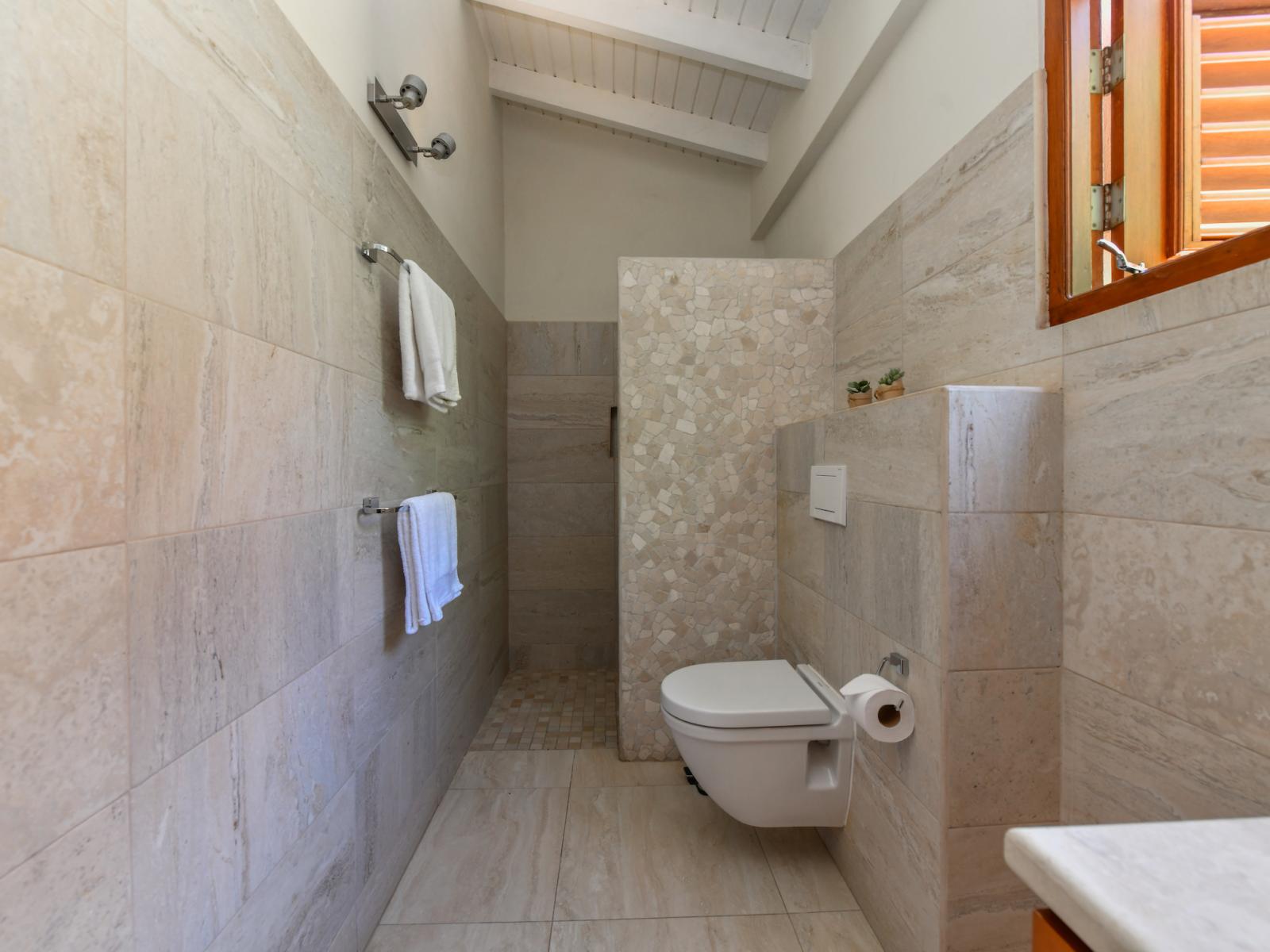 Step into luxury in Bathroom 3, featuring a spacious walk-in shower designed for your comfort and relaxation, promising a refreshing and rejuvenating experience.