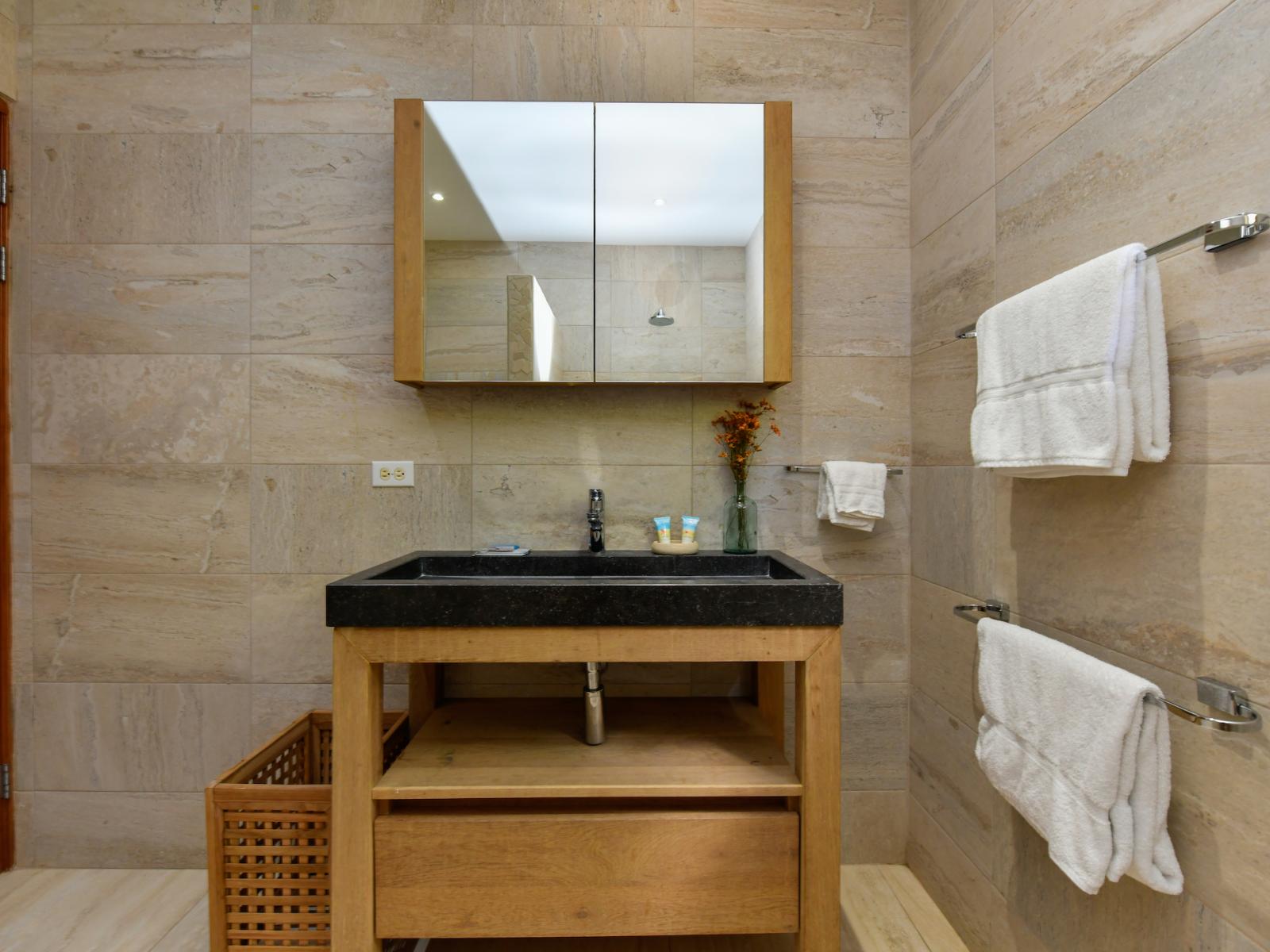 Indulge in modern convenience with Bathroom 4, featuring a sleek walk-in shower for a refreshing and invigorating bathing experience.