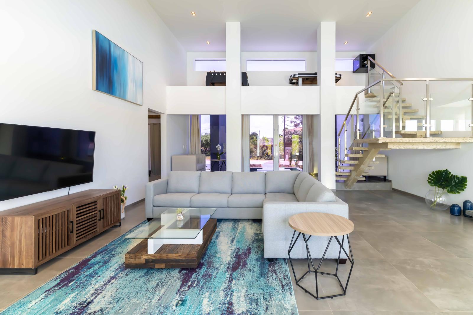 Opulent Living Area of the Villa in Noord Aruba - Smart TV and Netflix - Chic and contemporary living room design with clean lines and modern furnishings - Comfy Sofas - Play Area for fun time
