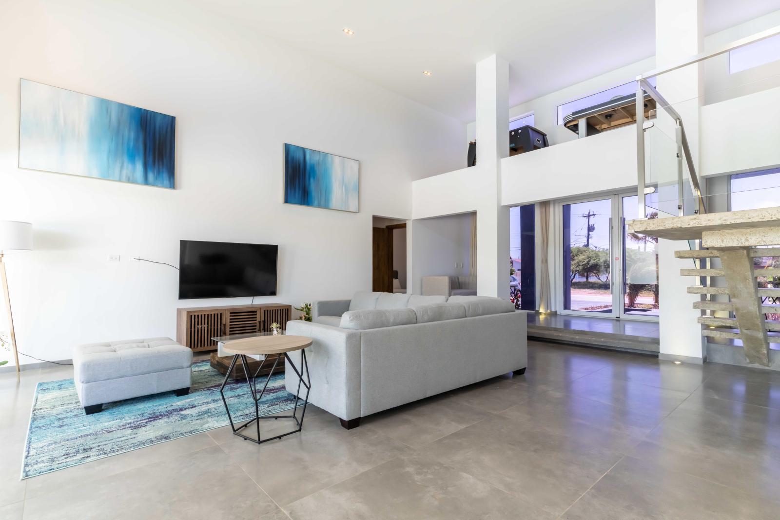 Spacious Living Area of the Villa in Noord Aruba - Smart TV and Netflix - Elegant Decor, adding sophistication - Comfy and Cozy Sofas - Easy access to outdoor dining and pool