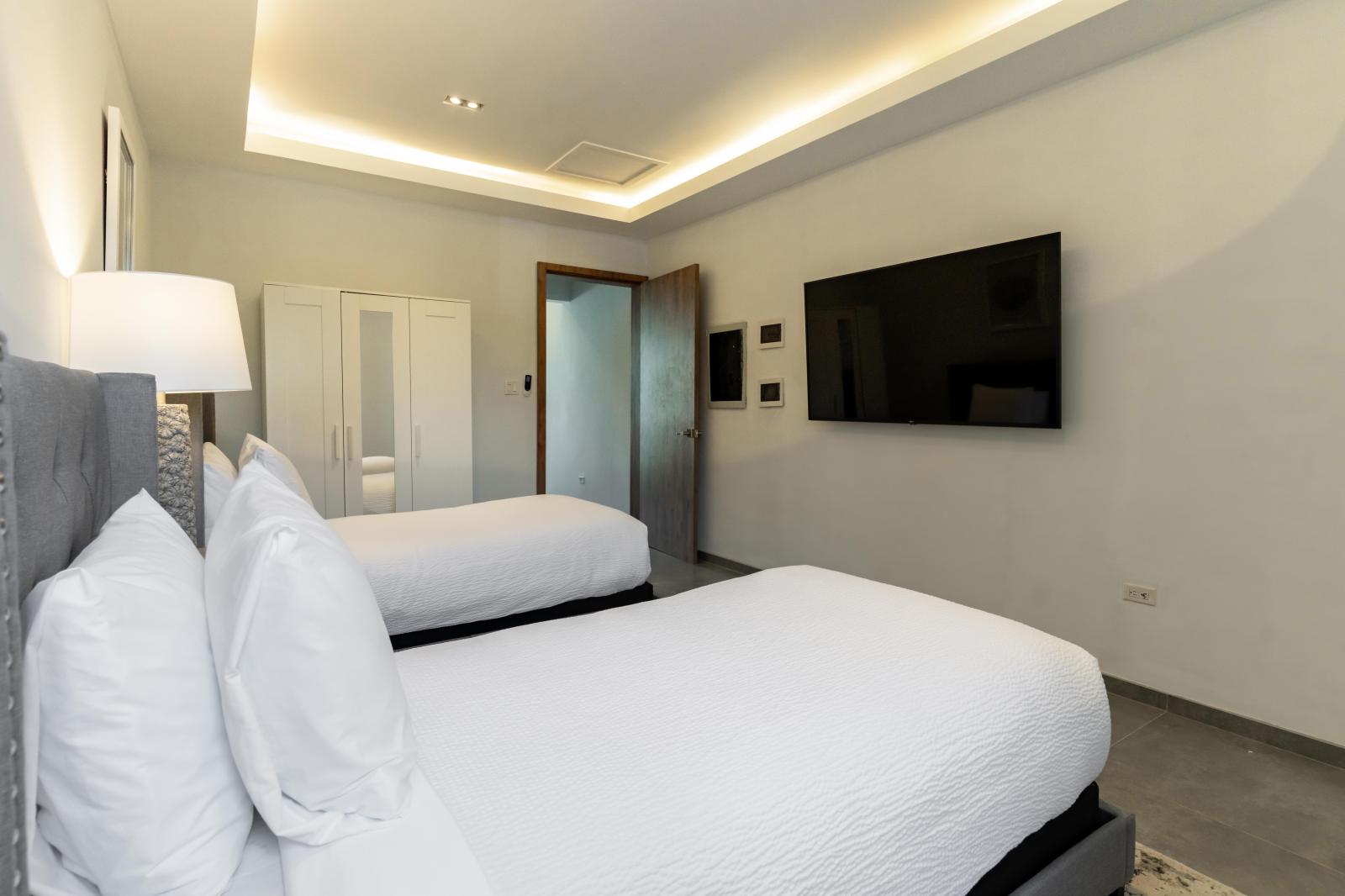 Cozy up in Bedroom 2, where two twin-size beds offer flexibility and comfort for a restful night's sleep – perfect for friends, siblings, or solo travelers looking for their own space