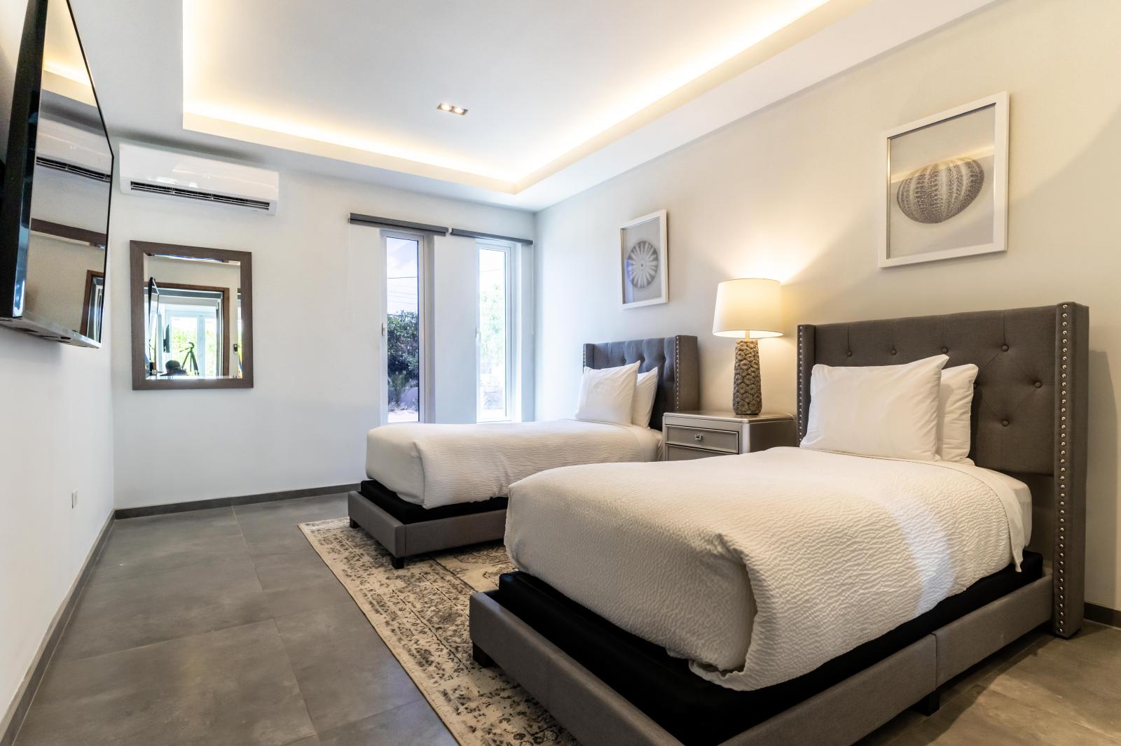 Superb Bedroom of the Villa in Noord Aruba - Lavish twin comfy bed -  Modern bedroom with sleek design and ample natural light - Smart TV and Netflix - Elegant Decor