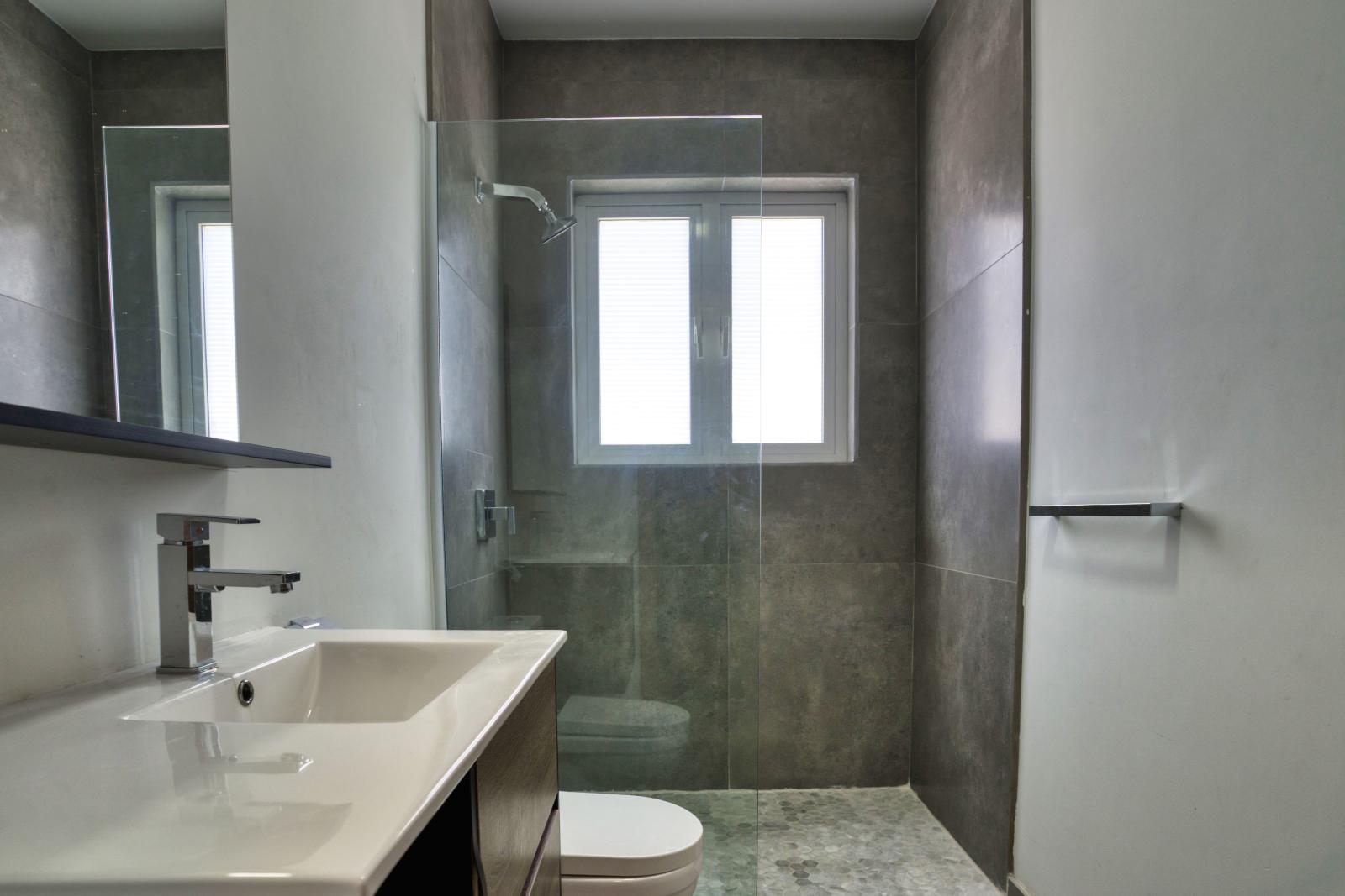 Indulge in the spaciousness and luxury of a walk-in shower in Bathroom 4 – a rejuvenating oasis where every shower feels like a pampering escape.