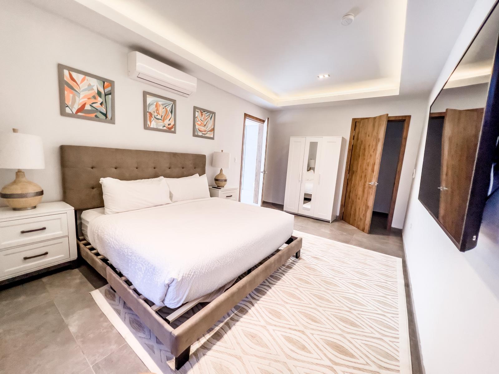 Relax and unwind in Bedroom 6, complete with a wall-mounted flat-screen television – your personal sanctuary for movie nights and lazy mornings.